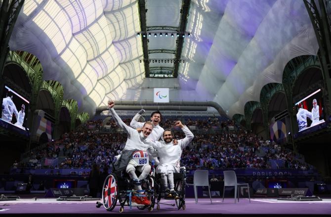 Piers Gilliver, Dimitri Coutya and Oliver Lam Watson of Team Great Britain celebrate winning bronze during the Wheelchair Fencing Men's Epee Team Bronze Medal match between Team Poland and Team Great Britain on day ten of the Paris 2024 Summer Paralympic Games at Grand Palais on September 07, 2024 in Paris, France.