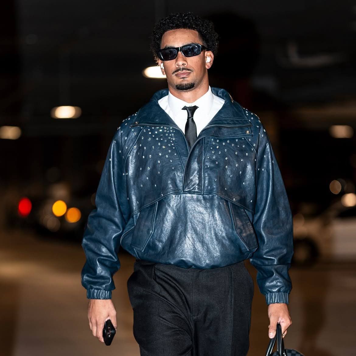 Green Bay Packers QB Jordan Love arrives at the stadium in his leather jacket.
