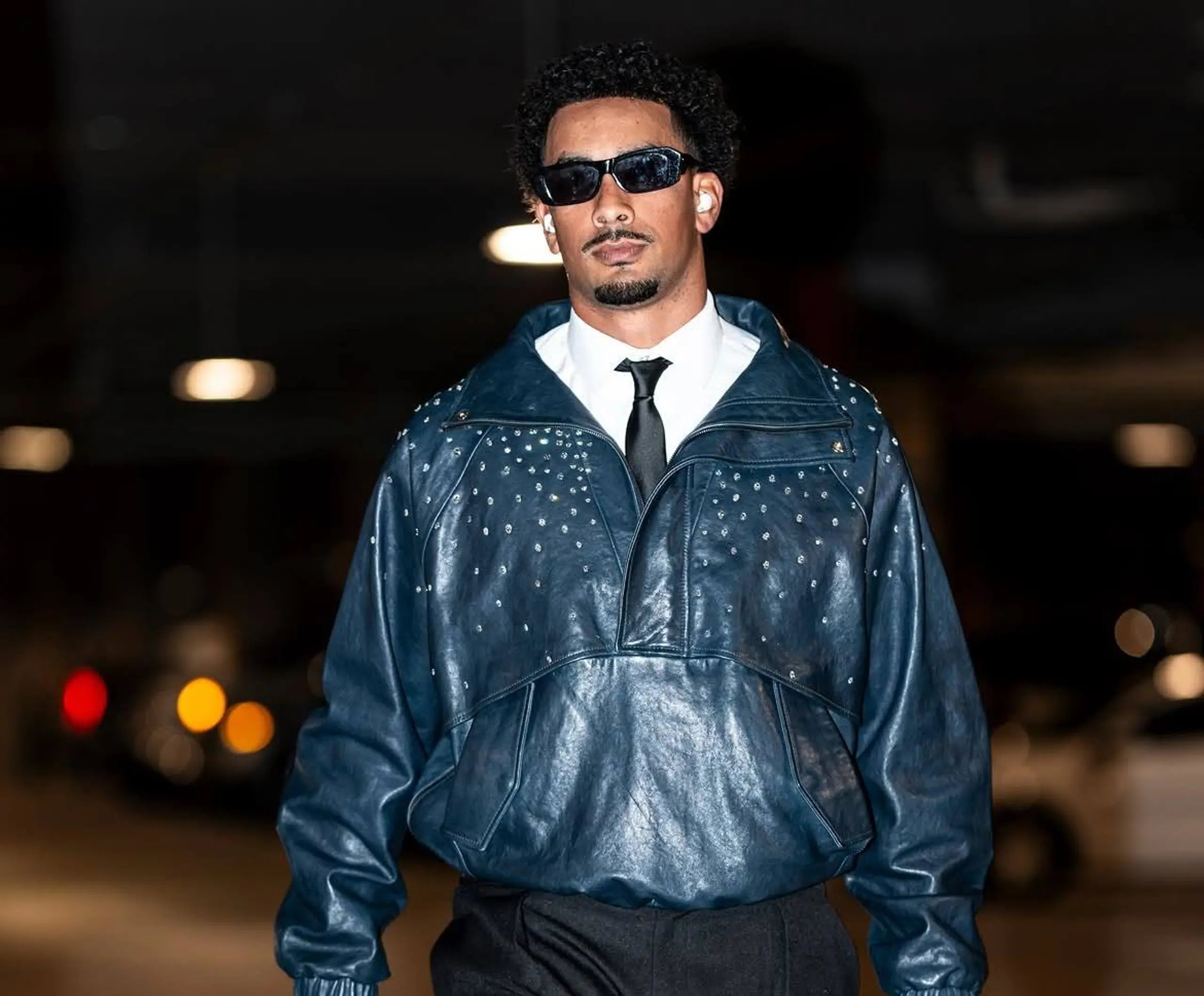 Green Bay Packers QB Jordan Love arrives at the stadium in his leather jacket.