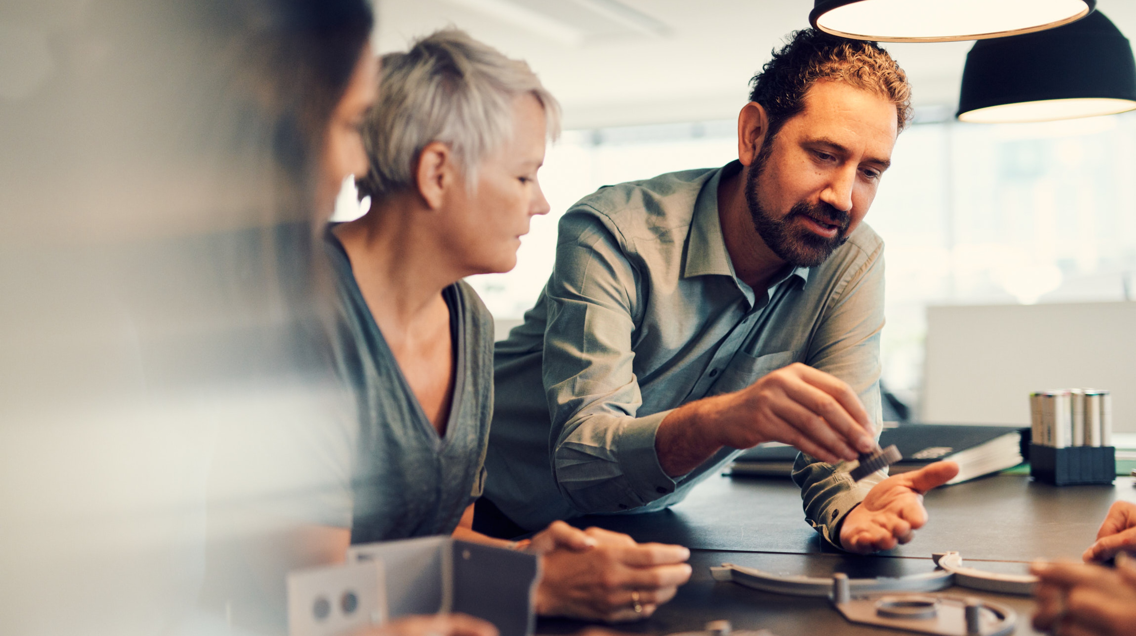 Three people working in a tech lab