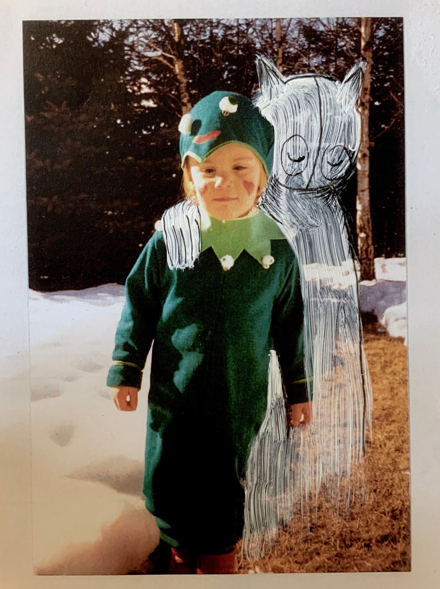 Vintage photo of Claudia Six as a child in a jester costume, overlaid with a drawn mythical creature by her side