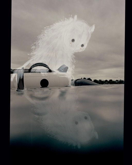 A freediving bujo at the surface of the see with a drawn character sitting on top of it. 