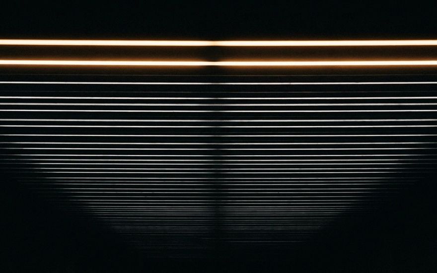 Gestapelte waagrechte Lichtlinien im Dunkeln, die oberste deutlich heller als alle darunter