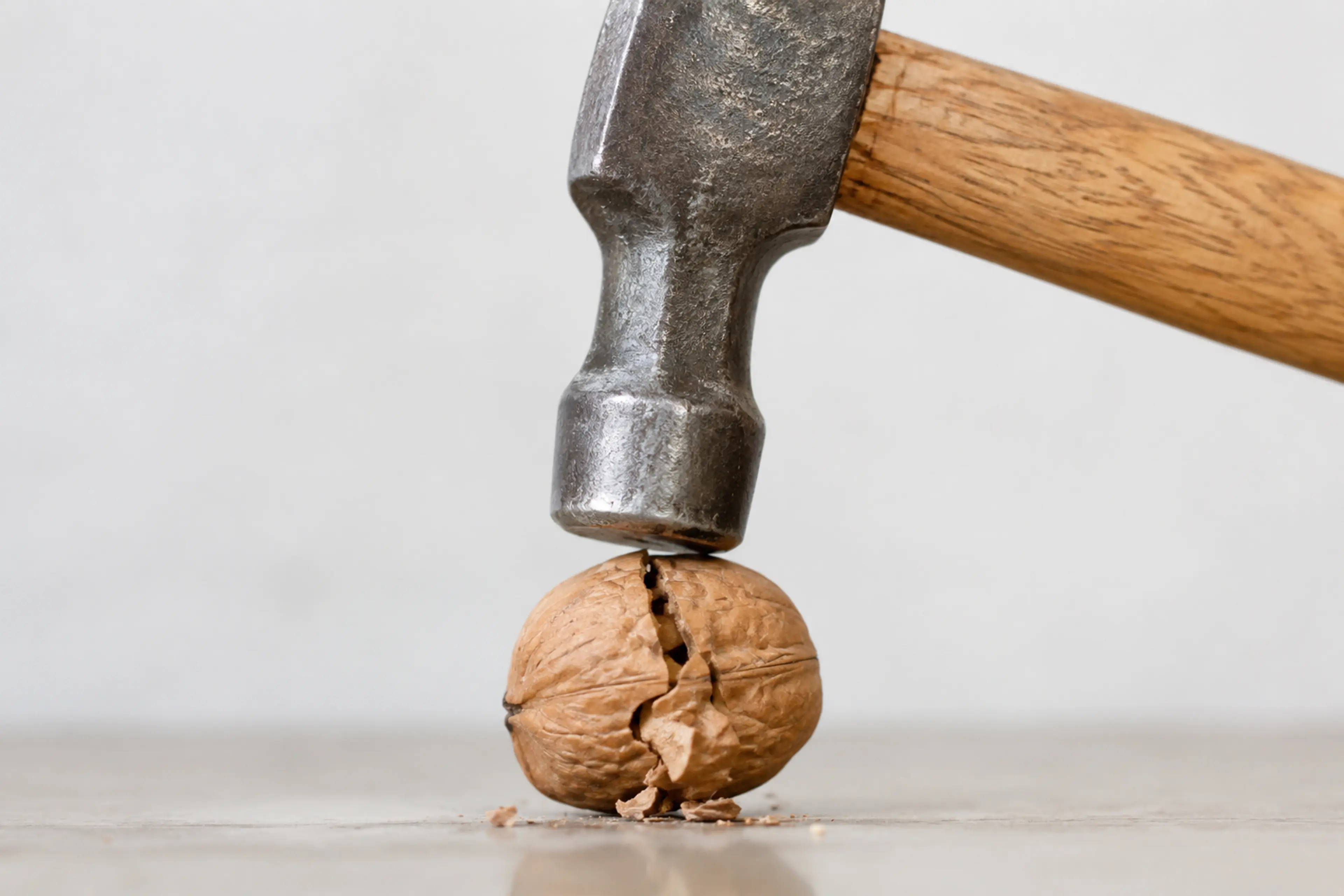 Hammer cracking a nut