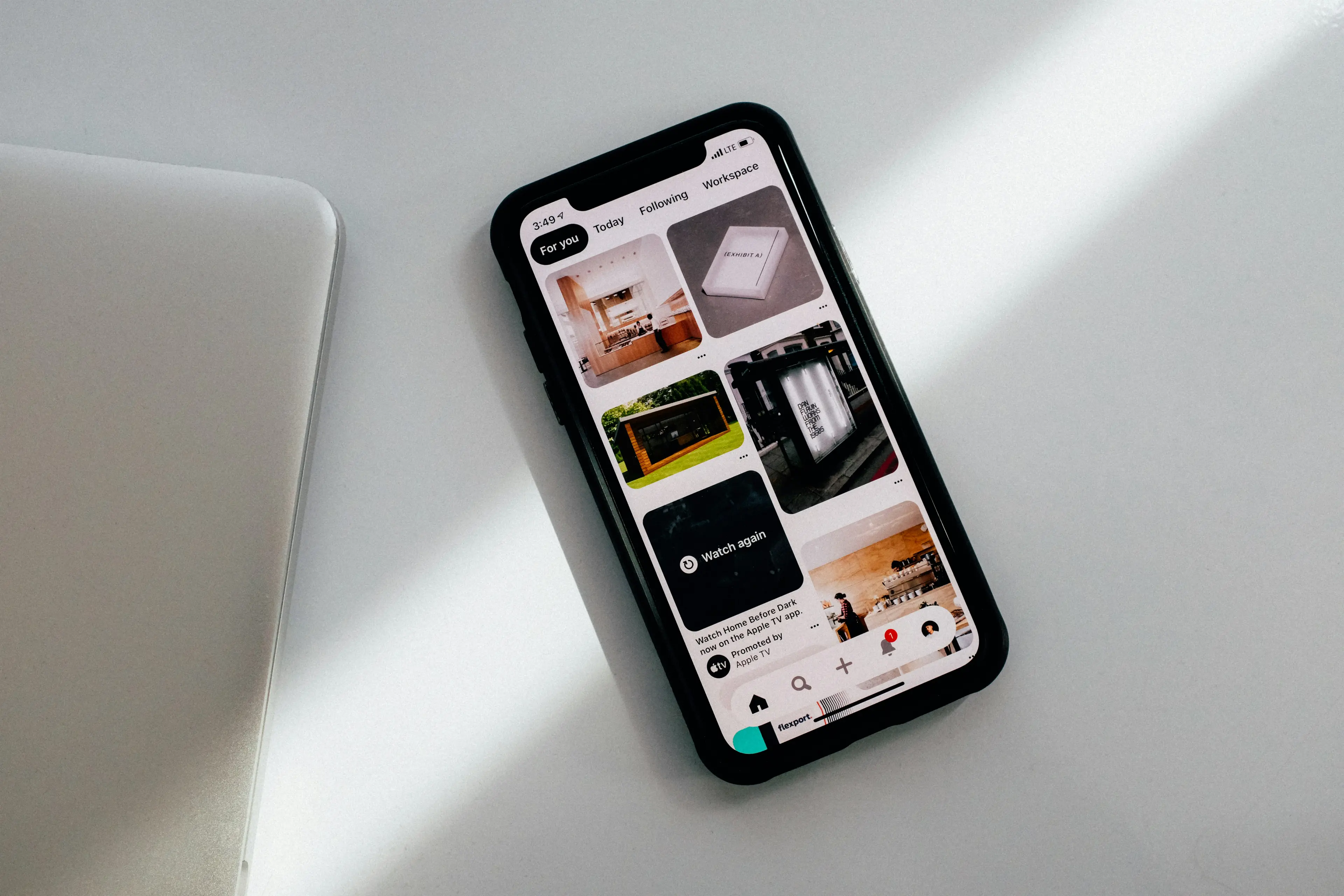 Mobile phone showing a grid of photos. Photo by charlesdeluvio on Unsplash