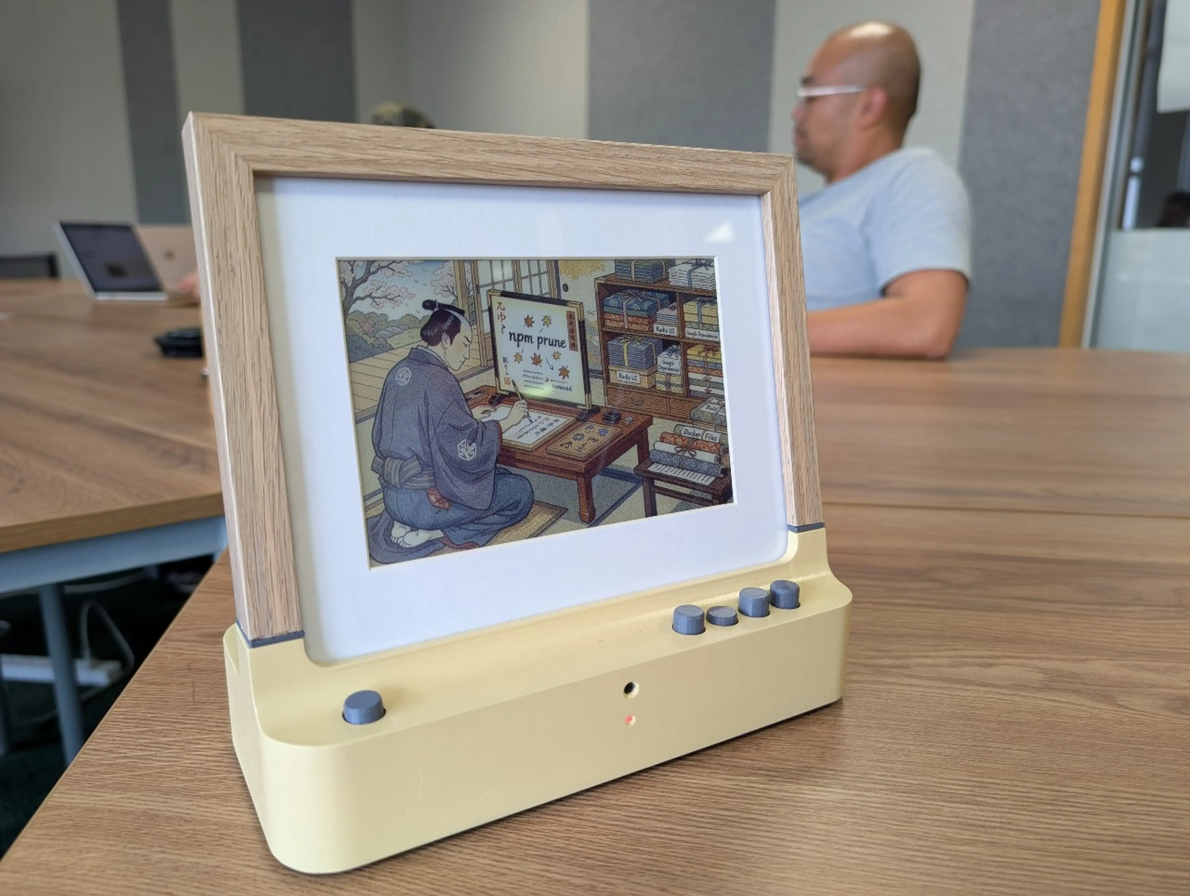 Evesdrop device on a desk listening to conversation within a room.