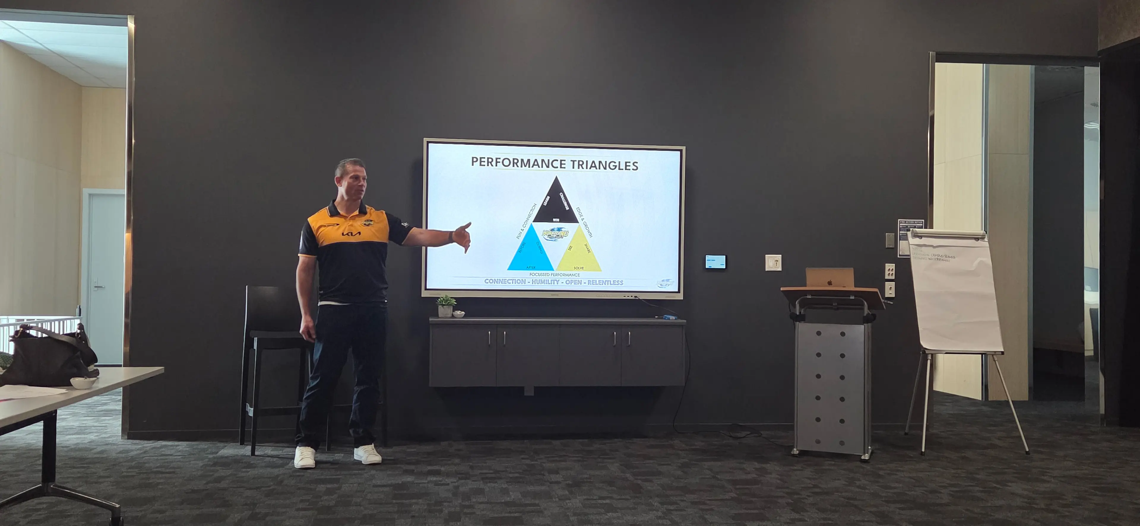 Tony Philp stands in front of presentation