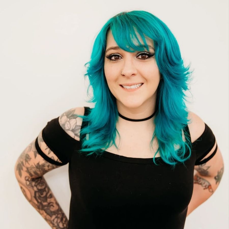 Jessica Szalai, owner of MidoriFoxx, with layered teal hair