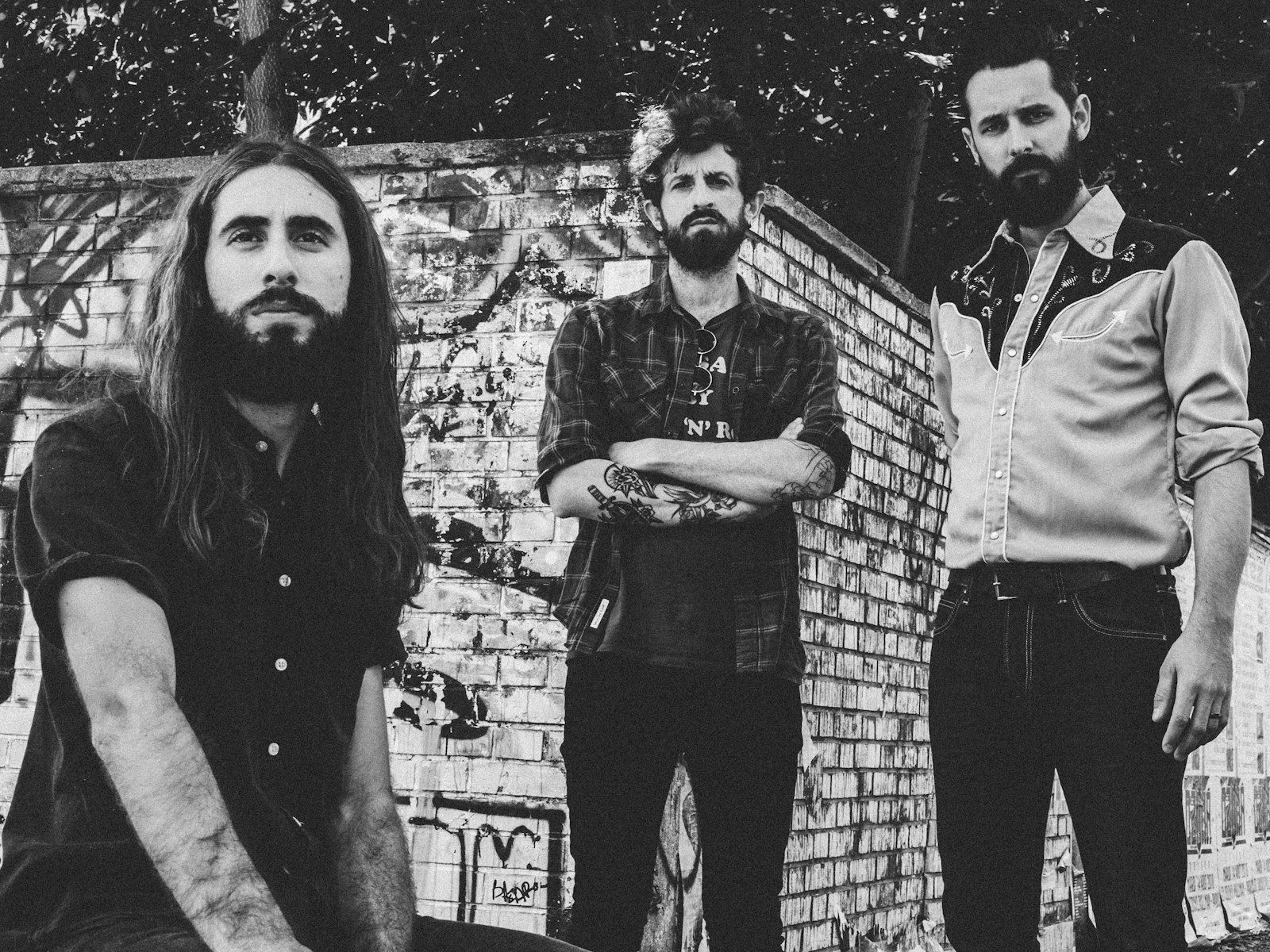 Black and white portrait of a three-person band