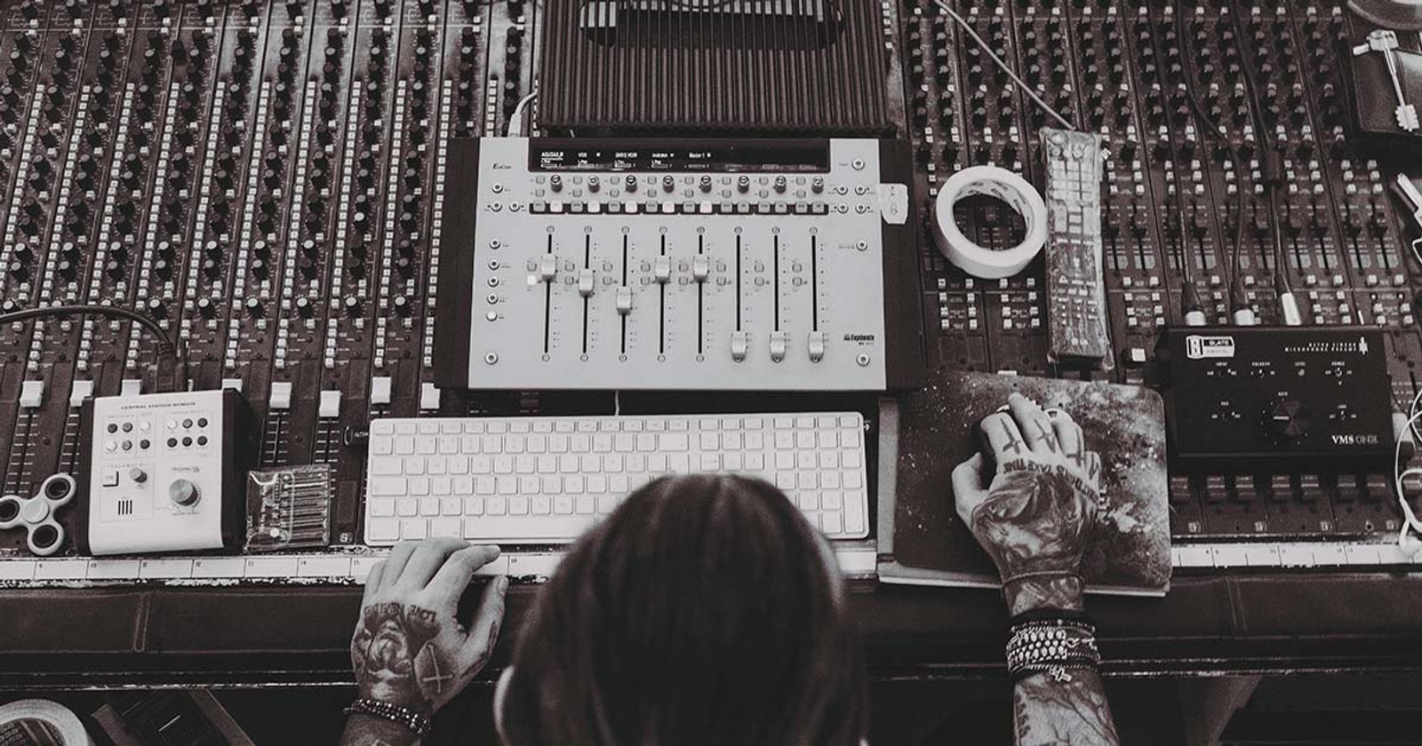 audio engineer at mixing board