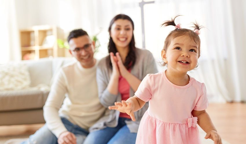 A parent holds a toddler — what's at stake in wealth management isn't a portfolio, it's a family's next chapter