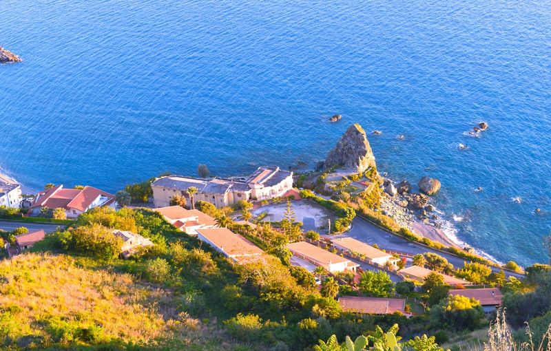 Top view of a cliff on the coast of calabria surrounded by green hills overlooking the sky and blue sea Amantea (calabria)