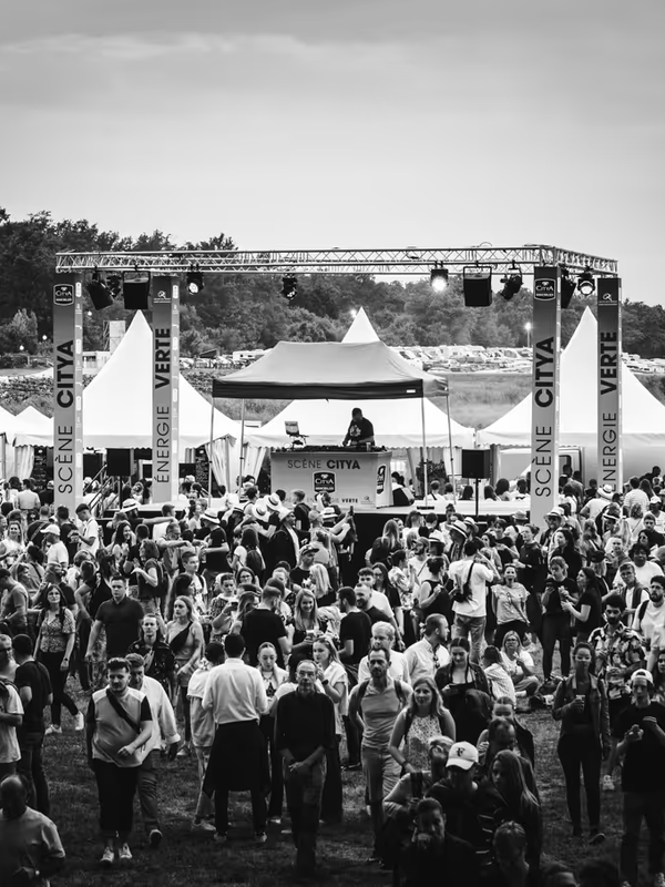 Site du festival en noir et blanc, foule devant la scène City Verte et tentes blanches
