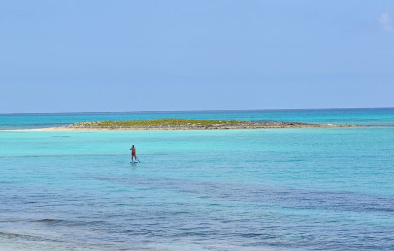 Turtle Bay ocean area on Green Turtle Cay, Bahamas with Man on pier