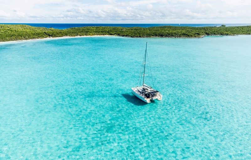 Aerial view of Catamaran anchored in turquoise waters at Shroud Cay, Exuma