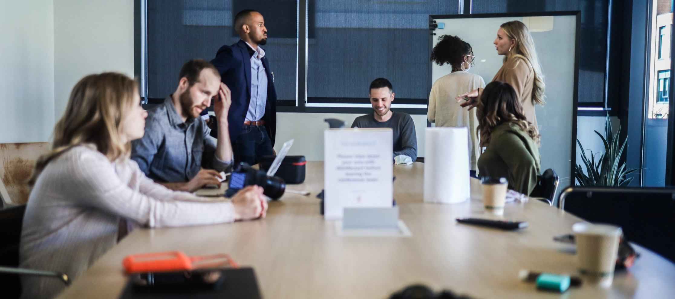 Group of people in meeting room with whiteboard