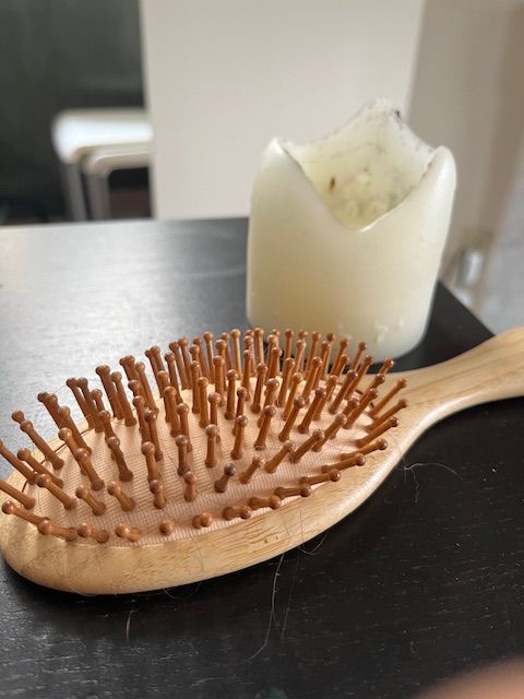 Hairbrush and Melted Candle