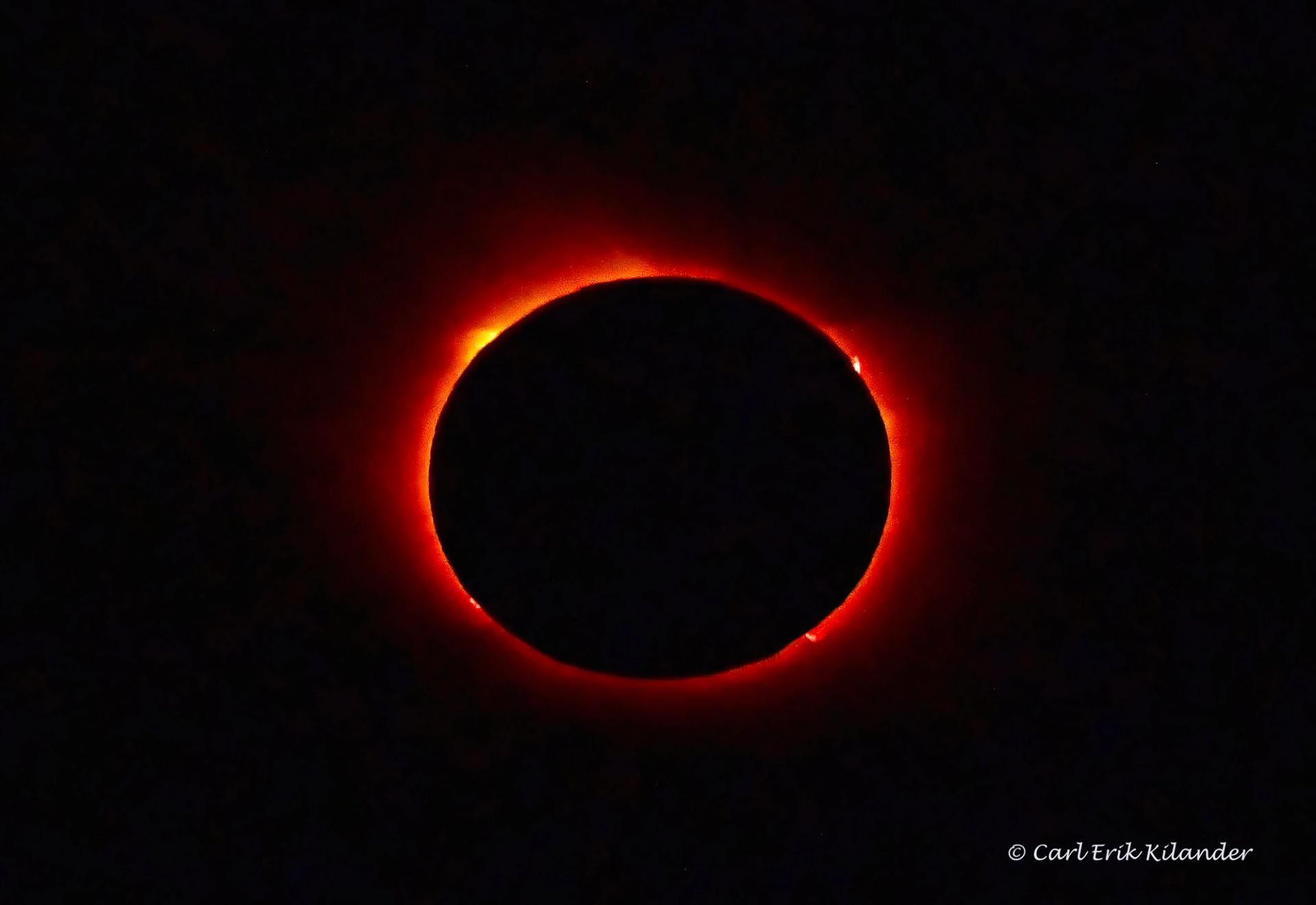The Sun's white corona surrounds the black disc of the Moon during a total solar eclipse