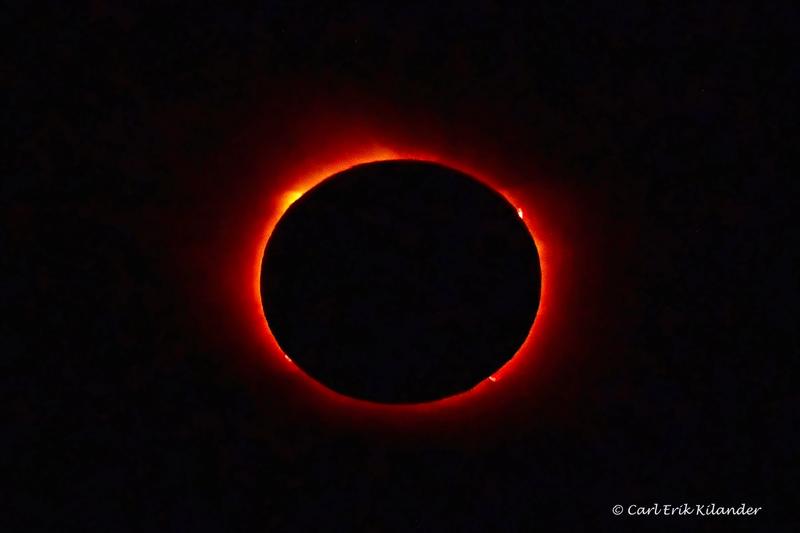 The Sun's white corona surrounds the black disc of the Moon during a total solar eclipse