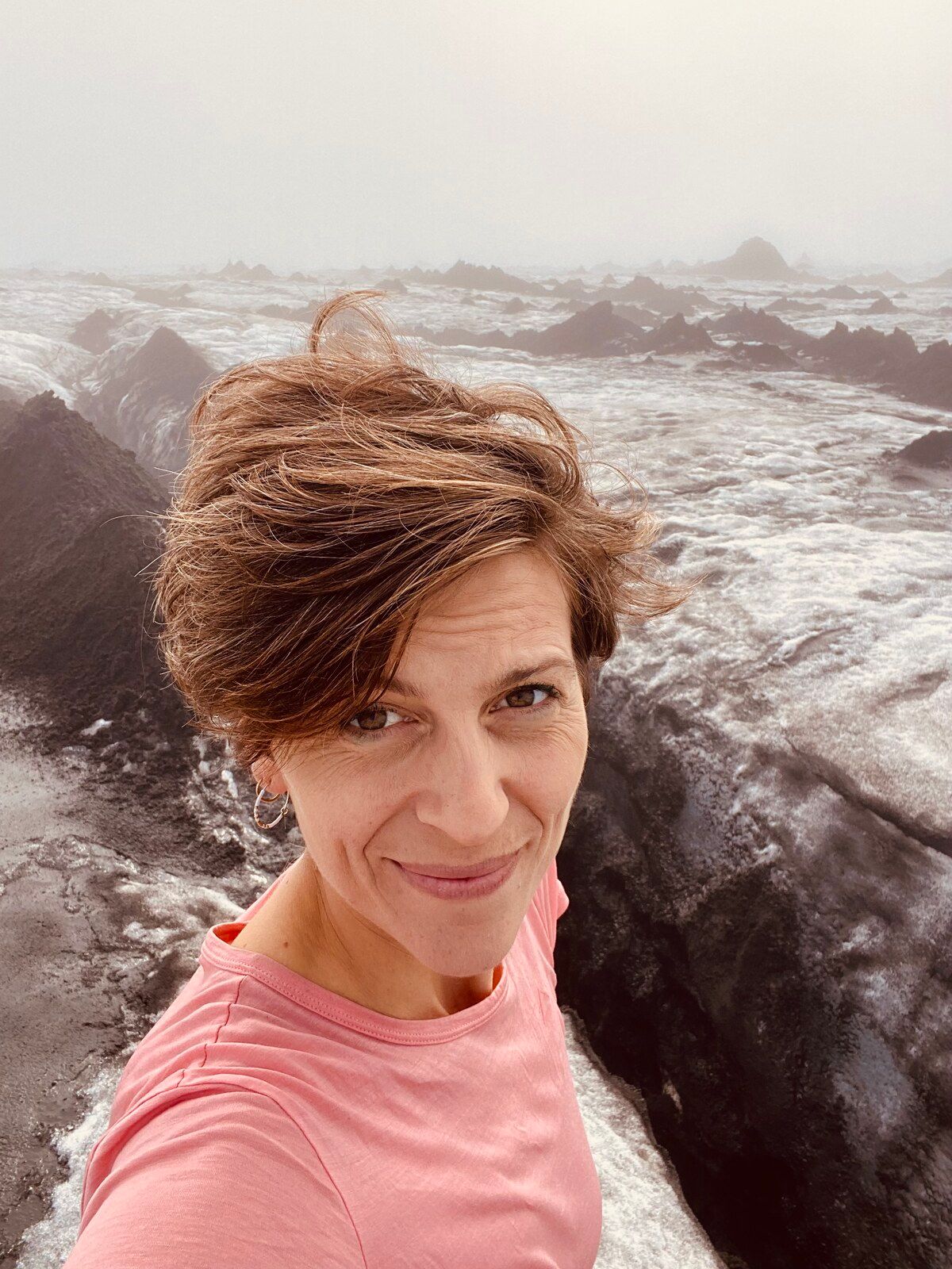 Elsebeth Molberg Thing in the Icelandic highlands, windswept, a glacier behind her
