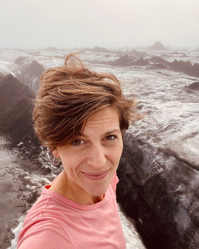Elsebeth Molberg Thing in the Icelandic highlands, windswept, a glacier behind her