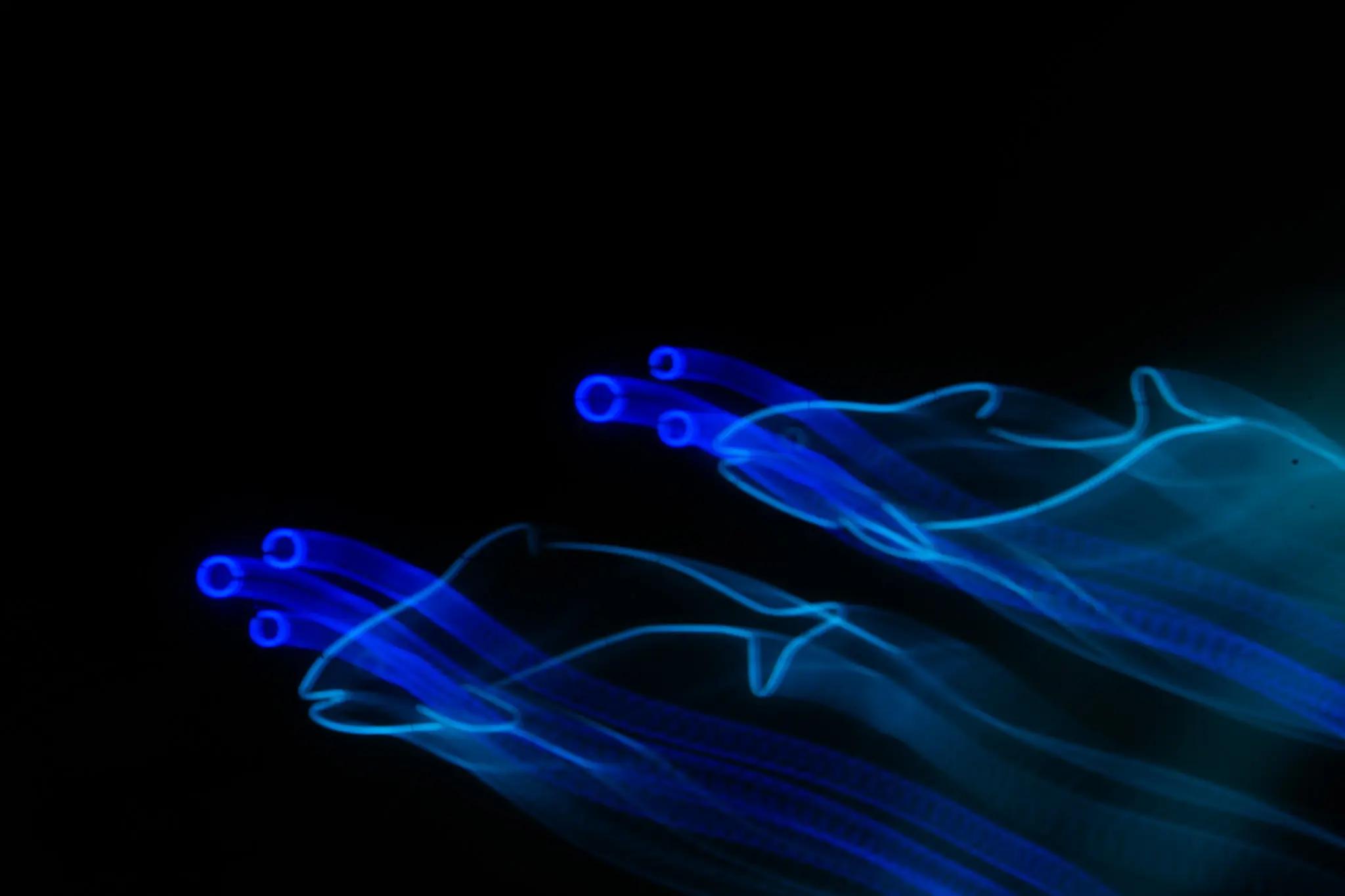 Electric blue light repeating as a compact gesture in black