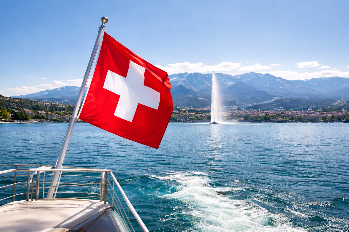Swiss flag on Lake Geneva with the Alps in the background, a symbol of economic stability in Switzerland