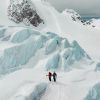 two skiers standing in mountain landscape