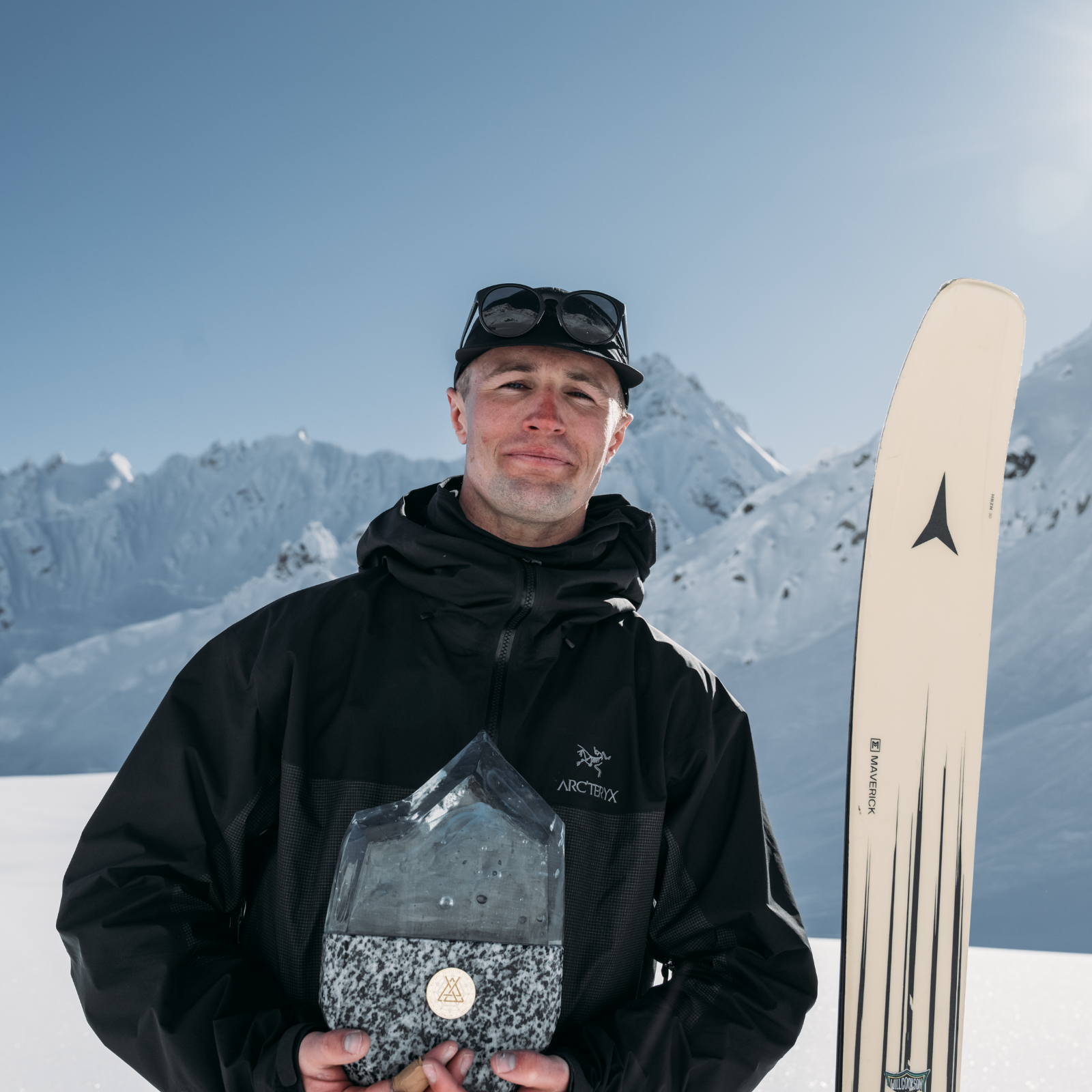 Craig Murray showing off an award in the sun
