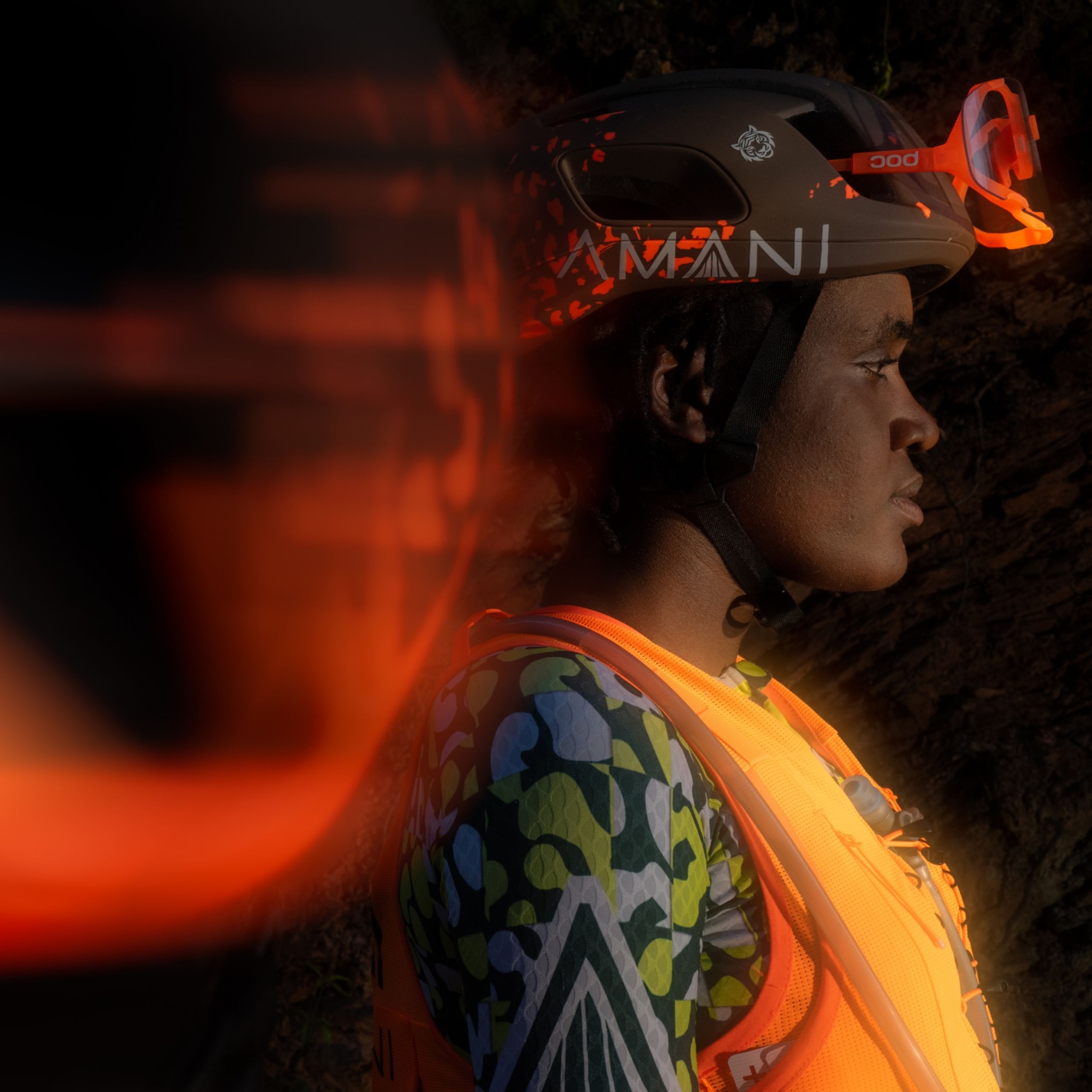 Amani cyclist wearing the new team fluorescent orange POC kit