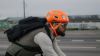 Image of cyclist riding in urban terrain in high vis colors