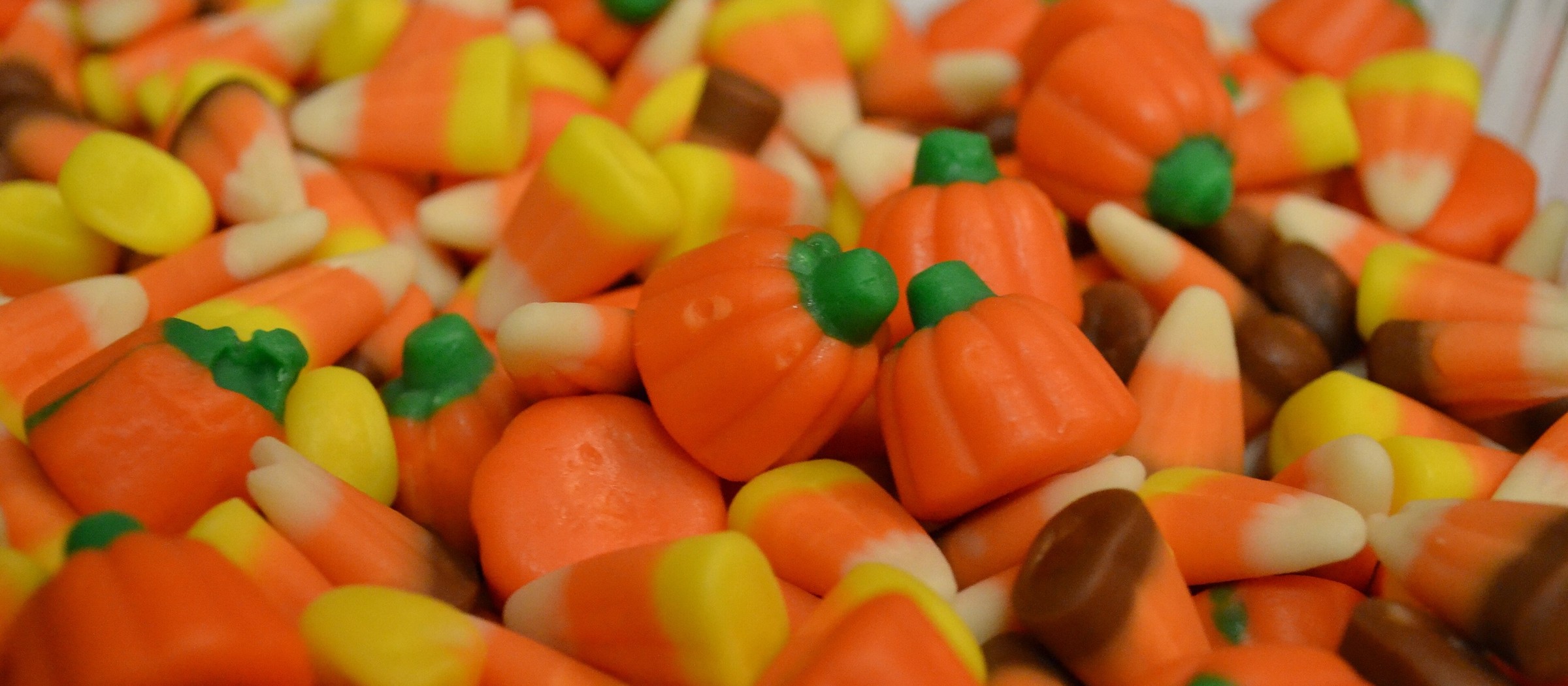 A close-up of candy corn and candy pumpkins
