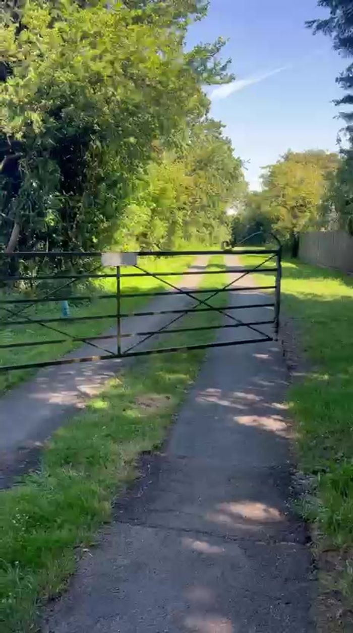 Turning off the lane through the farm gate — from the walkthrough video (temporary — swap for polished photography later)