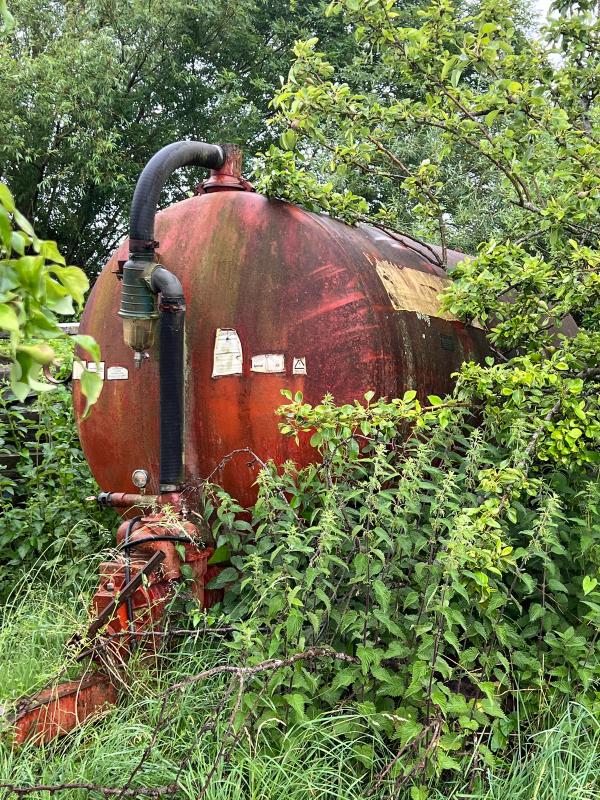 An old agricultural tank, reclaimed by the hedgerow