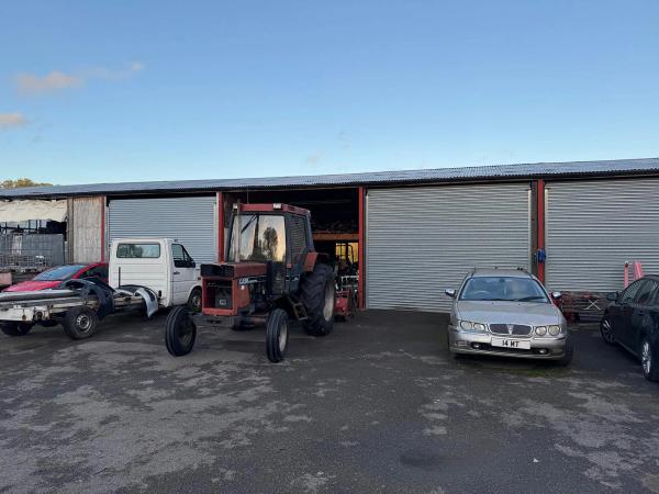 Tractor in front of the barn before renovation