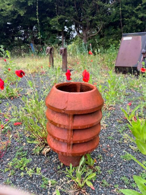 A terracotta chimney pot, a nod to the beekeeping to come