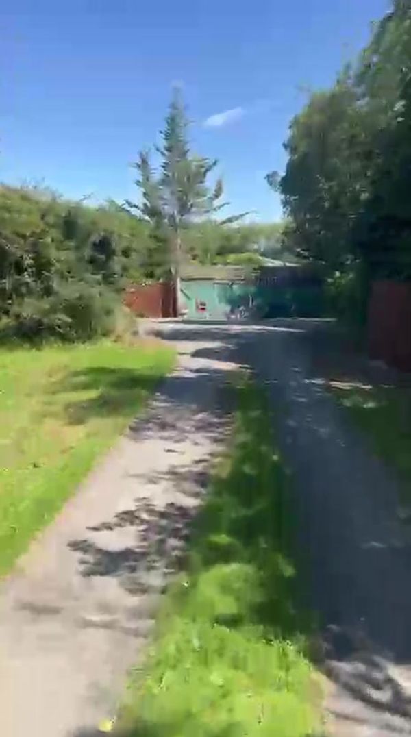 The approach into the yard, past the storage containers