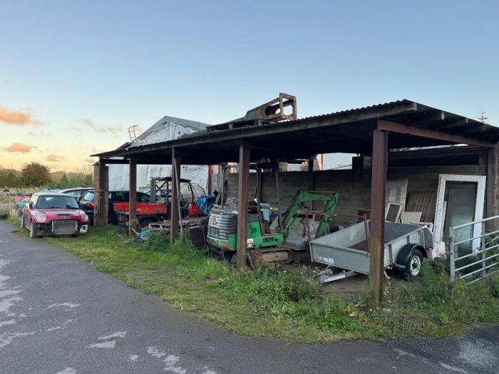 The farm buildings and yard before renovation