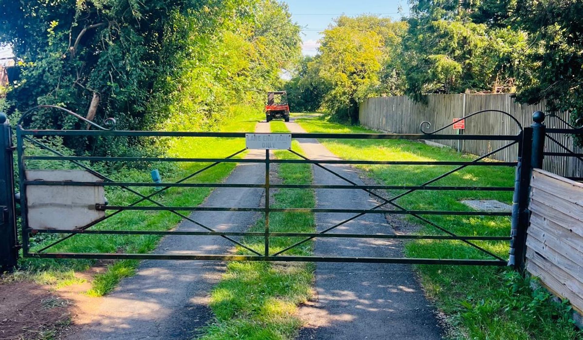 Looking through the farm gate down the lane at Tysall Farm Estate (temporary — swap for polished photography later)