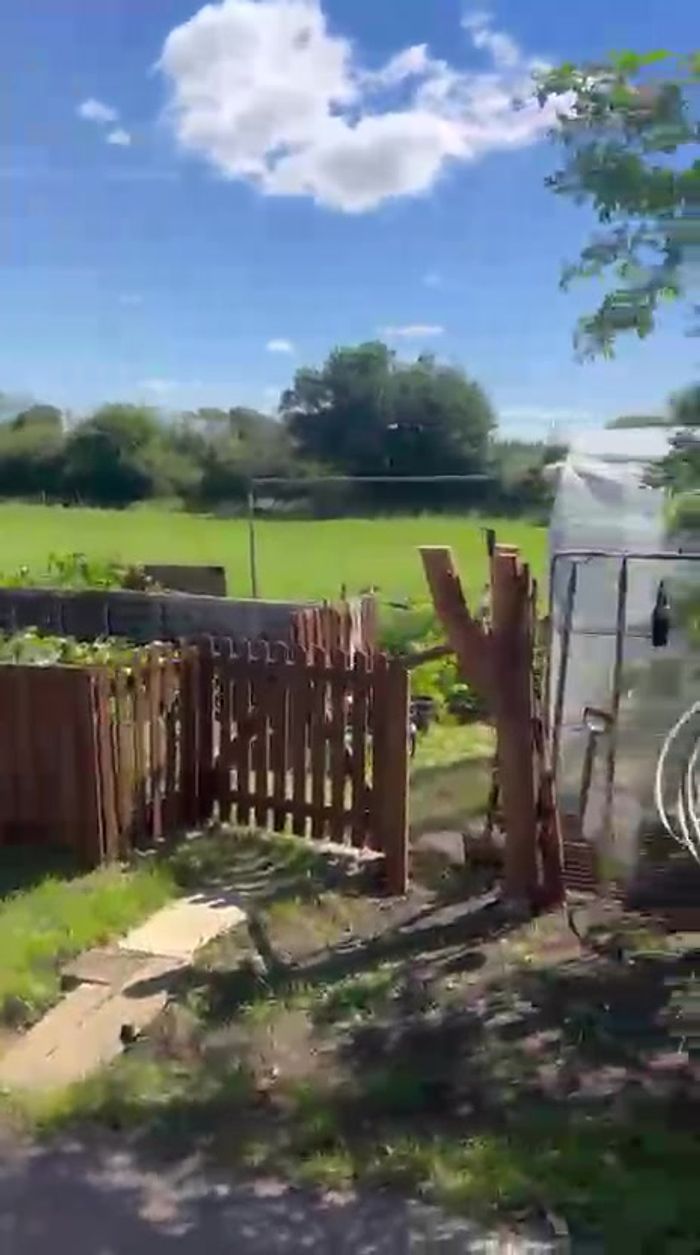 The kitchen garden fence and gate on the estate — from the walkthrough video (temporary — swap for polished photography later)