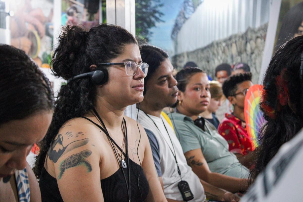 LAYCS Scholars listening to an event through headphones used for live interpretation