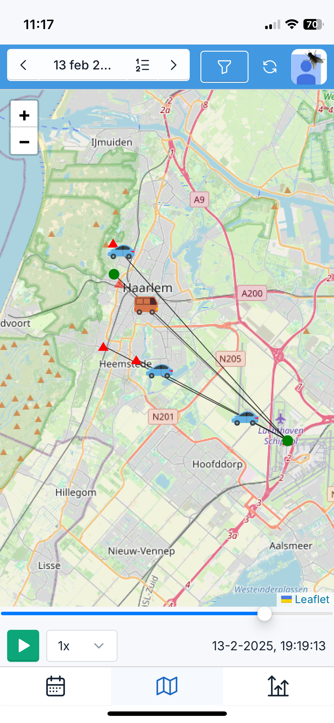 The replay map on a phone: cars and a van on the roads between Haarlem, Heemstede and Schiphol, with a scrubber and a play button underneath.