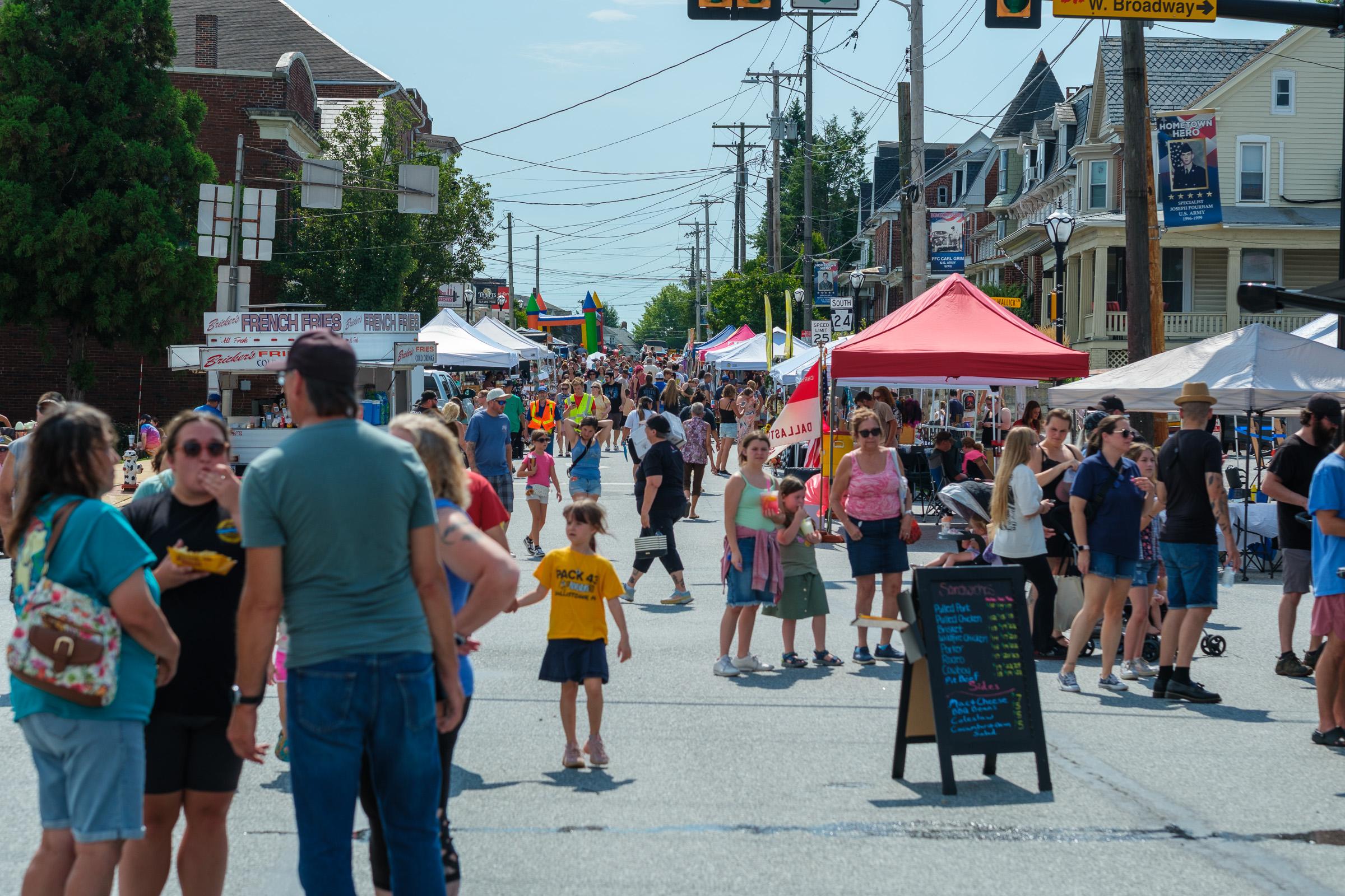 Looking down the street toward W. Broadway. Bricker's French Fries stand, a bounce house further down.