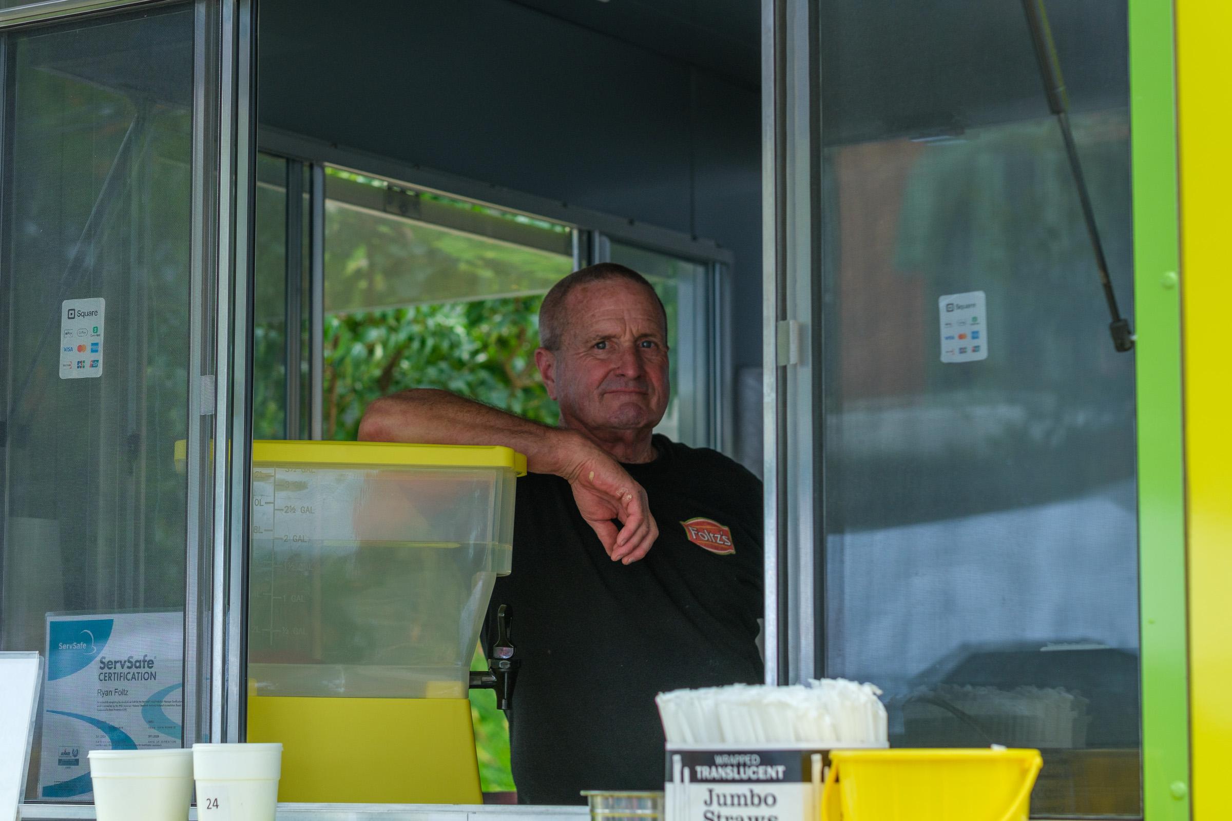The Foltz's guy leaning on the counter in his truck, arm over the lemonade dispenser, watching the street. He recognized me.