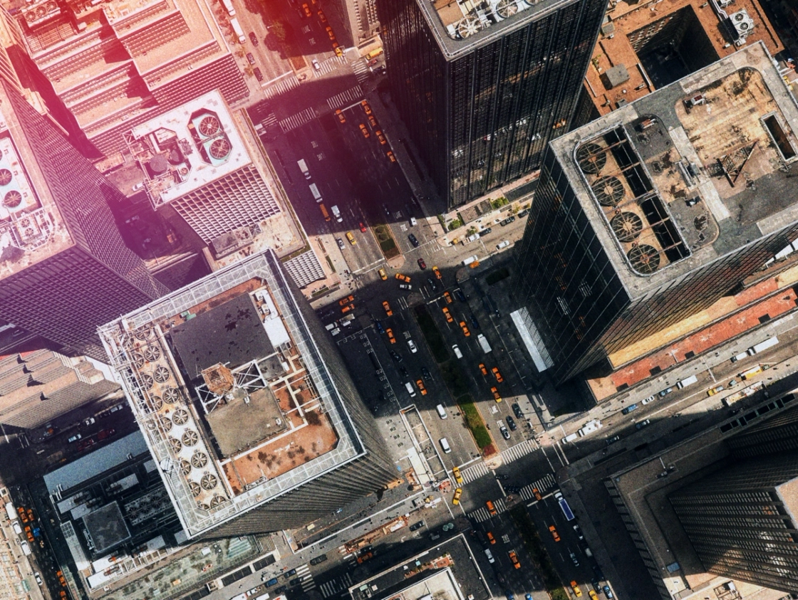 Aerial view of a bustling cityscape filled with numerous buildings and urban structures.