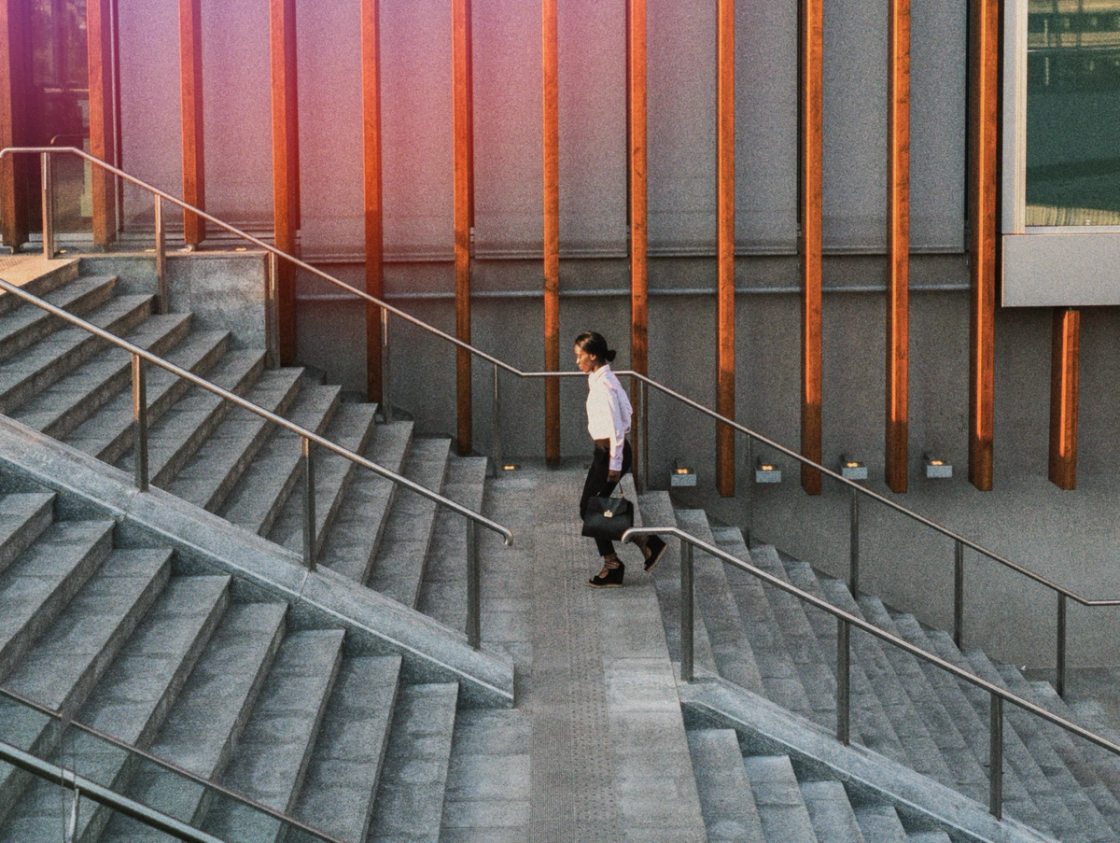 A person ascending a staircase, demonstrating determination and focus as they climb upward.