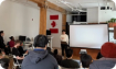 Presentation at Toronto Office, with a speaker facing a crowd 