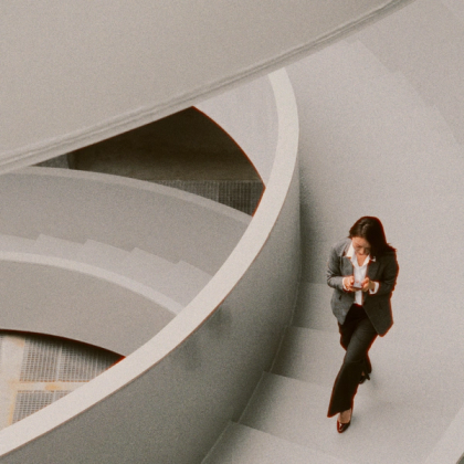 Close-up view of modern, curved, white staircases with a minimalist architectural design.