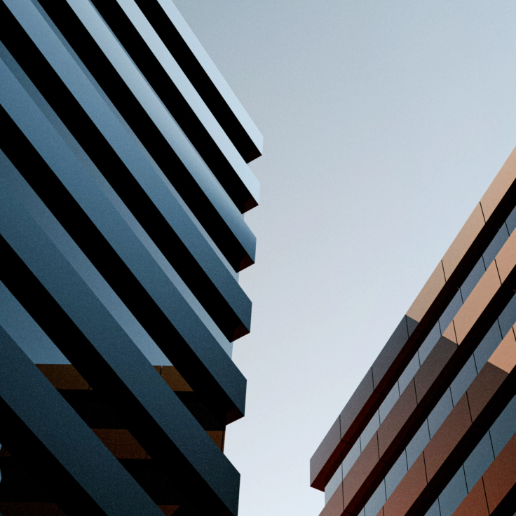 View of a cityscape through a ferry window, showcasing tall modern skyscrapers against a blue sky. The scene feels dynamic and urban.