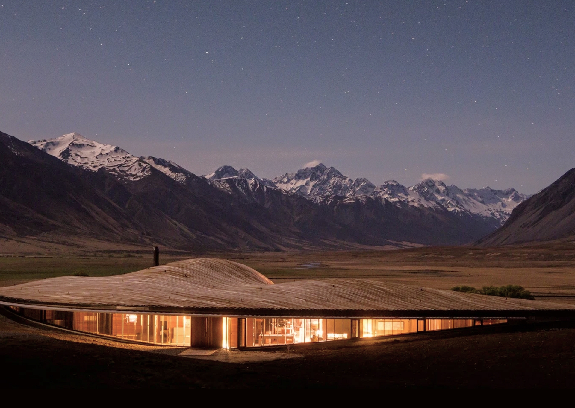 A luxury alpine lodge beneath snow-capped mountains